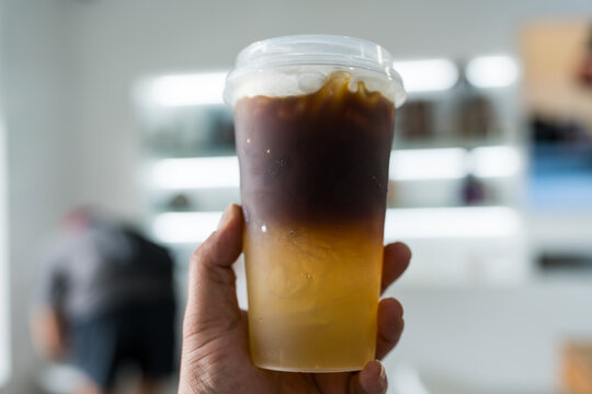 Black coffee mix orange. Iced americano with lemon  juice, refreshing beverage offers energizing morning boost on hand