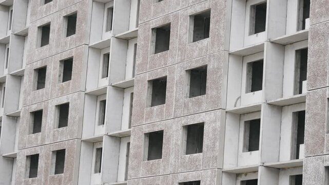 Focused view of raw concrete architectural elements. Close examination of unfinished concrete surface with panel details and textures