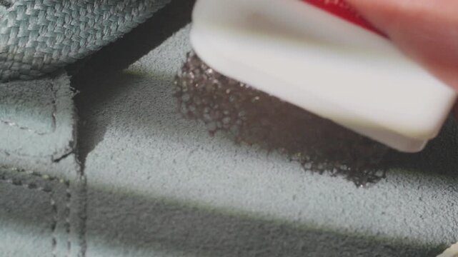 Soft techniques for removing stains from suede surfaces. Demonstrating gentle microfiber cleaning for staining on fragile suede material