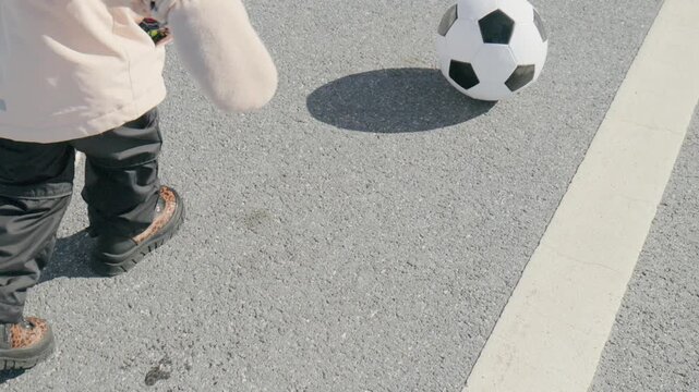 A fan walks with anticipation towards a weekend football match in the community