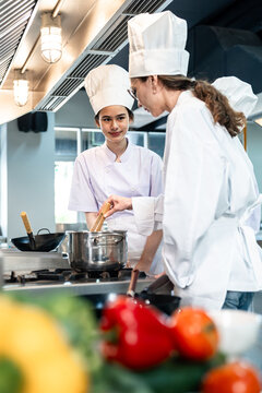 Chef team cooking training in professional kitchen, culinary staff collaboration for restaurant workflow, hospitality education, and food service branding visuals