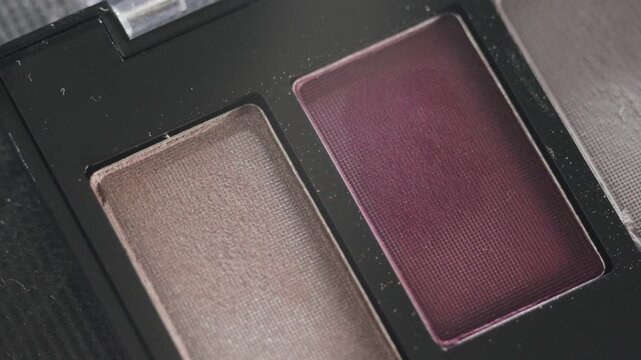 Sophisticated twopan eyeshadow in velvety tones. Detailed shot showcasing velvety texture and fine shimmer of cosmetic compact in studio lighting
