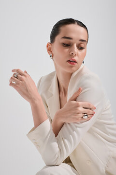 Glamorous woman showcasing modern elegance in chic white suit and stylish accessories
