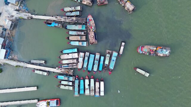 Abstract top view of colorful boats forming a pattern in marina water aerial
