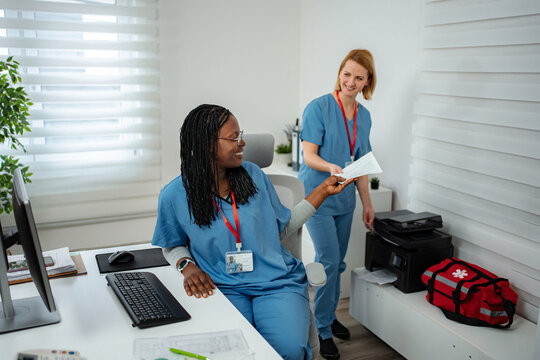 Two female medical staff collaborating in a clinic office