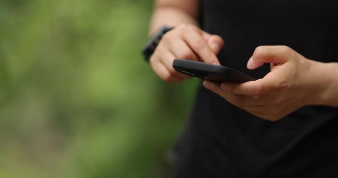 Woman using cellphone in the forest