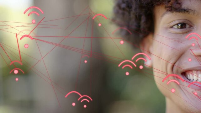 Adult male shifting into smile as red wifi arcs and lines sweeping across face, showing technology