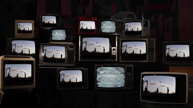 Wall of Vintage Televisions Showing Rural Kids Playing Soccer at Sunset - 4K