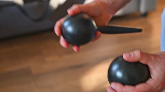 Man Shaking Large Black Maracas Close Up