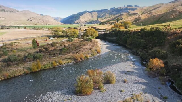 A scenic aerial view of a River and and Springvale Suspension Bridge, Napier Taihape Road, Manawatu-Whanganui, New Zealand, showcasing the natural beauty of the region.