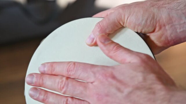 Man Performing Thumb Roll on Tambourine Close Up