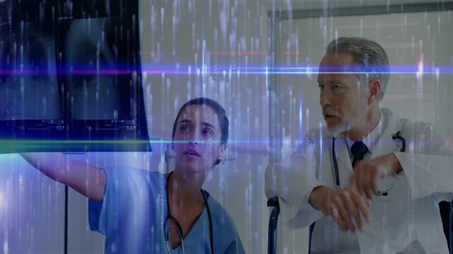 Nurse pointing monitor, doctor leaning, reviewing scan to diagnose as blue bands obscure display