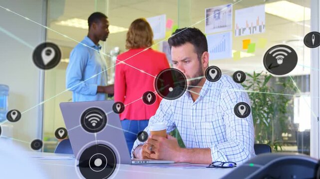 Working man holding coffee checking laptop at office table, network icons spreading, showing links