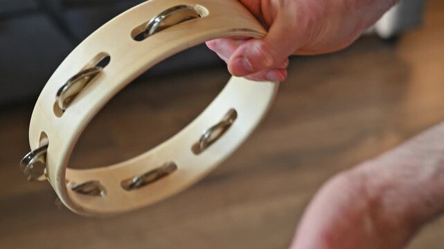 Slow Motion Video of Man Shaking Wooden Tambourine Close Up