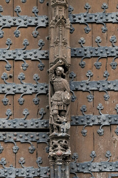 Medieval carved hinge detail on historic studded door