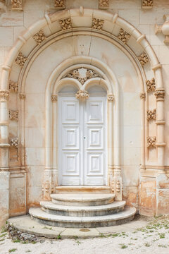 White ornate historic doorway with classical stonework