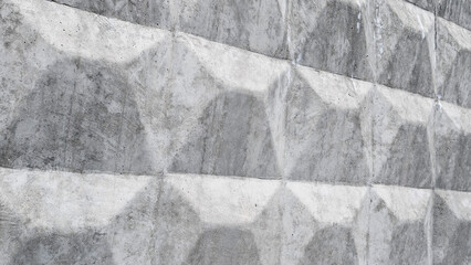 Concrete wall displaying strong geometric pattern and texture, forming an architectural background with brutalist block design, ideal for industrial or urban aesthetics © Newleks