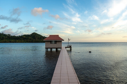 Sunset at Hurepiti Bay with Stilt Houses on Tahaa Island