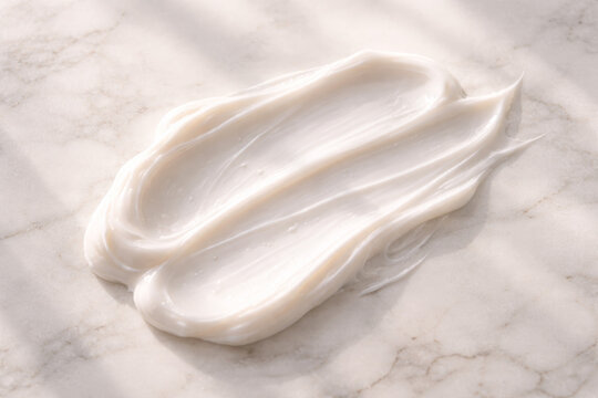 Smooth white cream spread on a marble surface