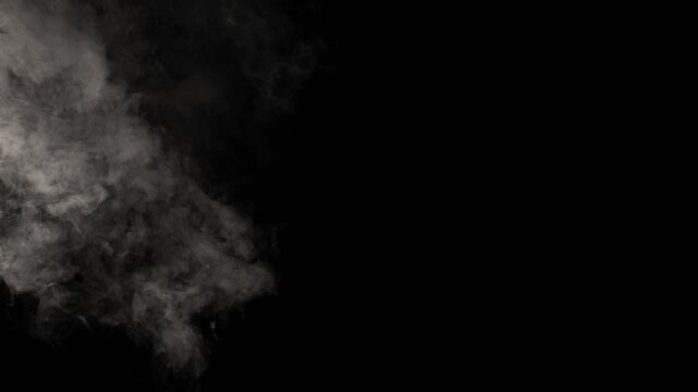 Smoke. Cloud of cold fog in blue light spot on black background. Abstract white smoke in slow motion. Light, white, fog, cloud, abstract, smoke, black, background, 4k, ice smoke cloud. Floating fog.