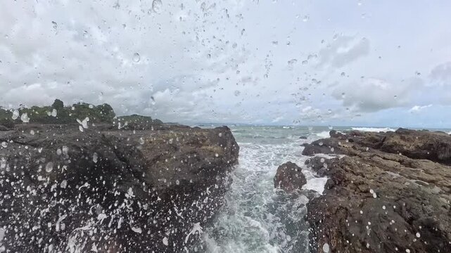 Rugged rocks frame a narrow channel of seawater along the coast of Torio, Panama