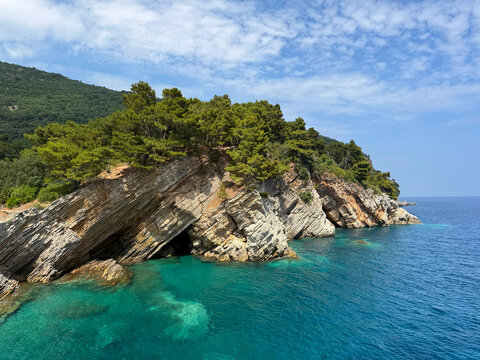 Turquoise sea and rocky coastline in summer.