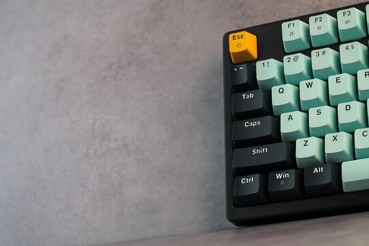 Mechanical Keyboard with Mint Green and Black Keys on Grey Background