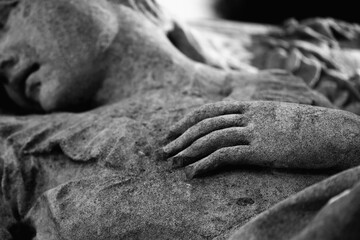 Fototapeta premium Resting angel statue in monochrome, symbol of peace, death and eternal rest.