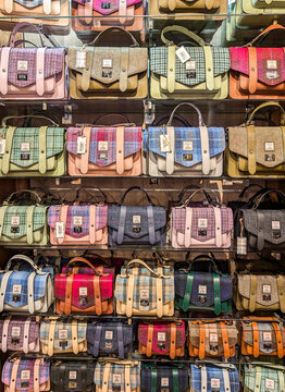 Edinburgh, UK, Dec. 26, 2024. Display of colourful Islander handbags crafted from Harris Tweed, showcased inside a shop in Edinburgh city centre.