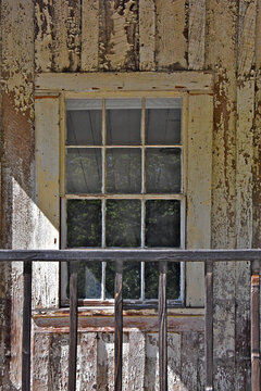 Weathered peeling window wall and railing 