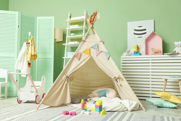 Cute wigwam and building blocks in stylish child's room © New Africa