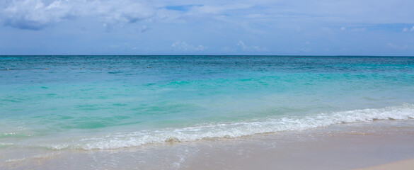 Obraz premium Caribbean Sea beach with white sand and clouds sky.