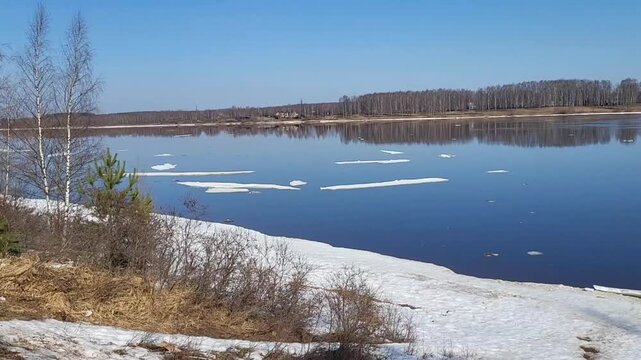 Ice floes on the river. On a clear spring day, white ice floes float along the Volga