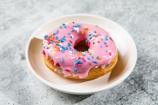 donuts with frosted pink glazed and sprinkles donuts.