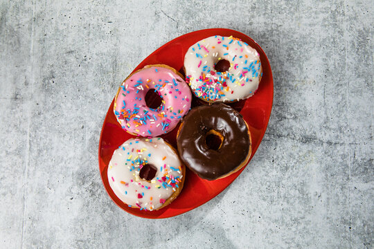 Glazed and decorated donuts showcasing a variety of flavors and toppings, with vibrant icing colors, perfect for a sweet treat or dessert