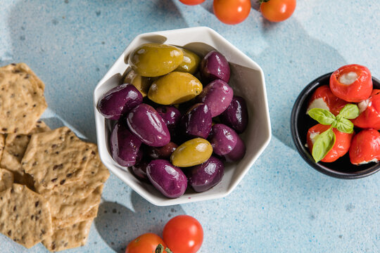 Mediterranean appetizer antipasti tapas bowls with green and calamata olives feta cheese stuffed pepper herbs