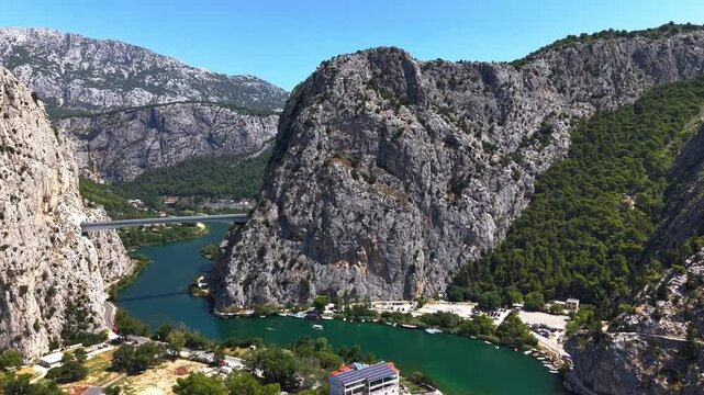 Aerial view of the Omis Bridge spanning the Cetina River canyon between two mountain tunnels in Omis, Croatia