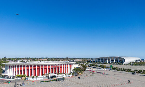 Aerial View Of Kia Forum And SoFi Stadium With Airplane Flying Overhead In Inglewood Los Angeles California
