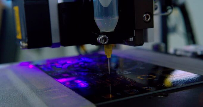 Modern high-tech production: Close-up of an automated high-precision machine assembling an electronic printed circuit board.