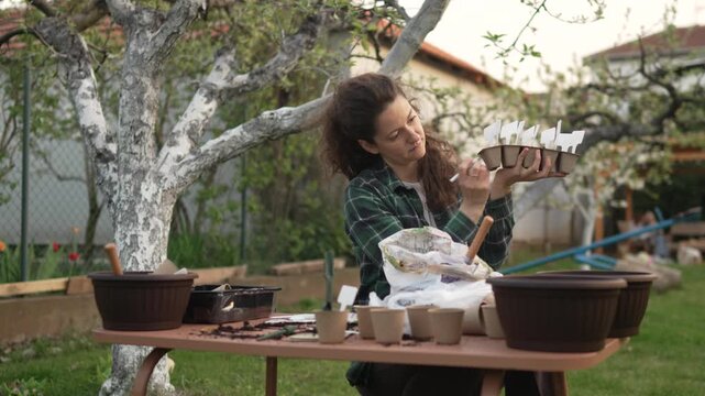 Female gardener preparing biodegradable peat pots for planting
