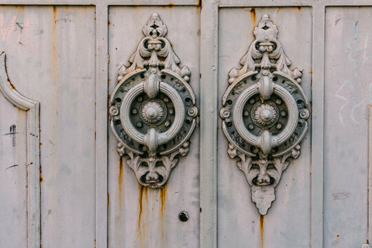 Ornate twin metal door knockers