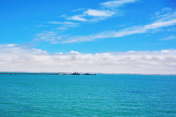 Fototapeta premium Dakhla beach with blue sky and clouds