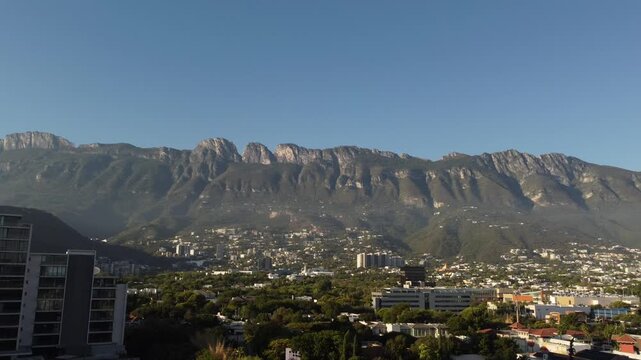 Aerial drone view of Cerro de la Silla mountain west side with residential neighborhood in Monterrey Nuevo Leon Mexico