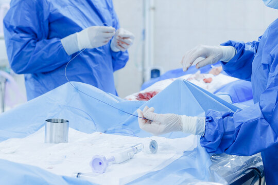 Cardiac catheterization operating room scene with surgical team and sterile instruments for interventional cardiology procedure