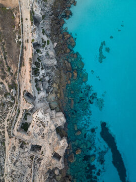 Aerial view of the turquoise waters and ancient tuff stone quarries at Cala Rossa in Favignana, Sicilia, Italy.