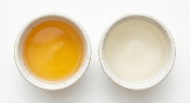 Small ceramic bowl of mirin and sake on white background