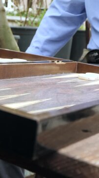 Playing Backgammon in Vertical Format &ndash; Dice Rolling and Hands Close-Up 4K