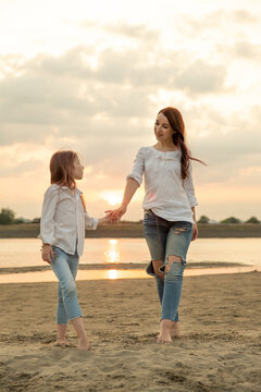 Mother and daughter walk outdoors. Woman and little girl spend time together on picnic. Mom and her child. Family concept. Selective focus.