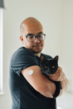 Young diabetic petting his kitten