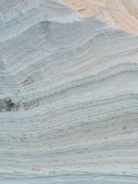 Aerial view of the white marl sedimentary rock layers of the Stair of the Turks with its unique wavy texture and geological formations Realmonte, Sicily, Italy.